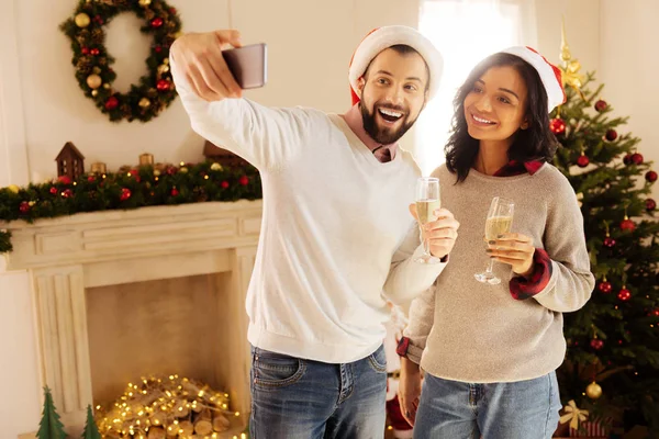 Cheerful couple taking selfie on New Year Eve