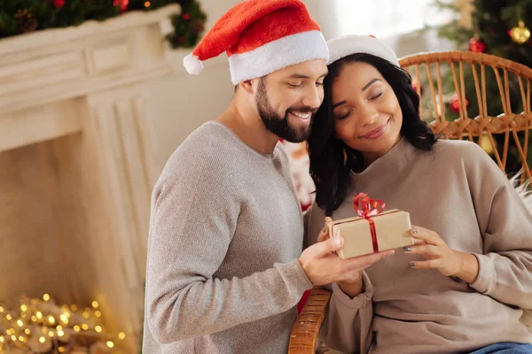 Gelukkige vrouw knuffelen man haar kerstcadeau geven — Stockfoto