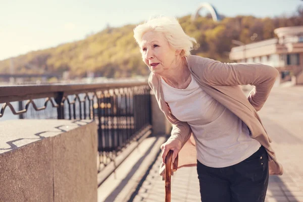 Woman suffering from lower back pain — Stok fotoğraf