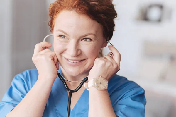 Portrait of beaming female doctor with stethoscope — Stok Foto