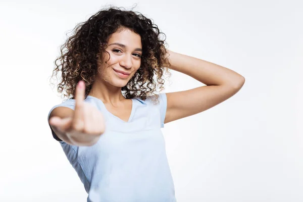 Beautiful curly woman beckoning someone with a finger — Stock Photo, Image