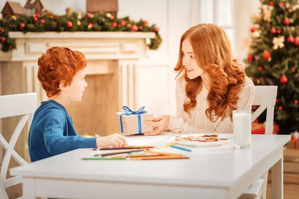 Loving mother giving son christmas present — Stock Photo, Image