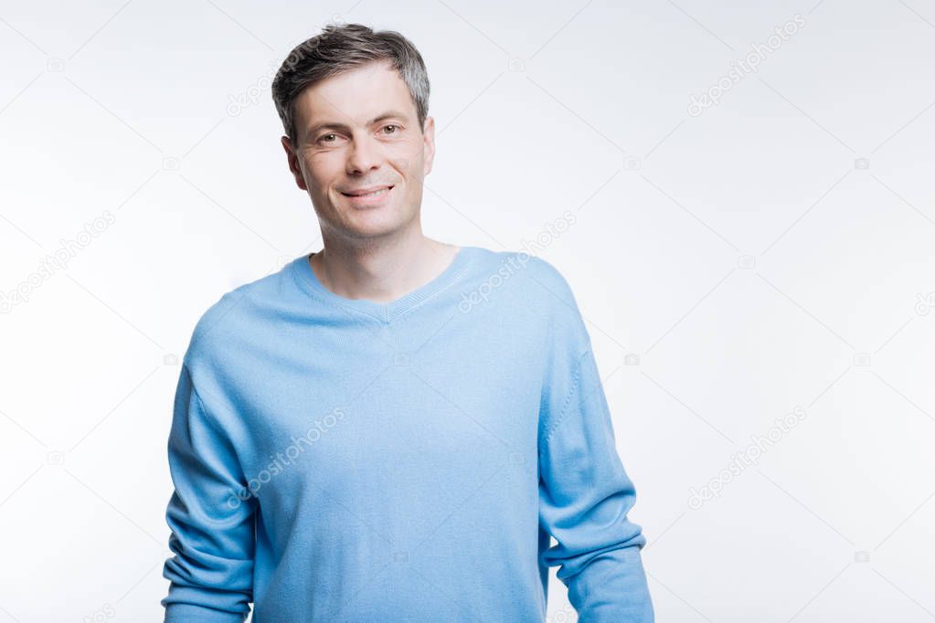 Portrait of handsome middle-aged man in blue pullover