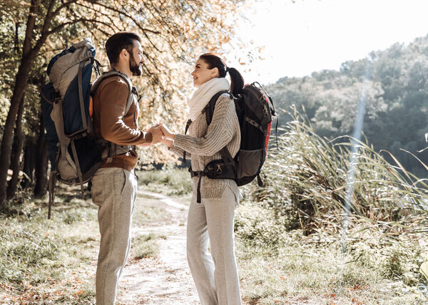 Profile of pleasant couple holding hands together