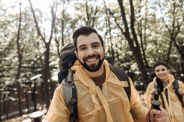 Cheerful friends wearing a raincoat — Stock Photo, Image