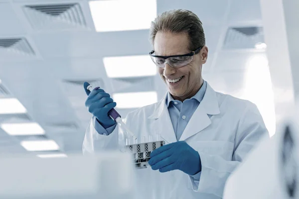 Cheerful nice scientist taking samples — Stock Photo, Image