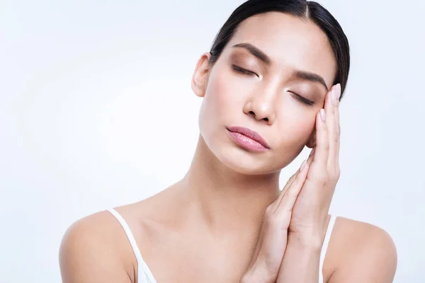 Beautiful woman folding her arms and resting face on them — Stock Photo, Image