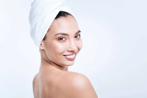 Cheerful young woman in towel turban smiling — Stock Photo, Image