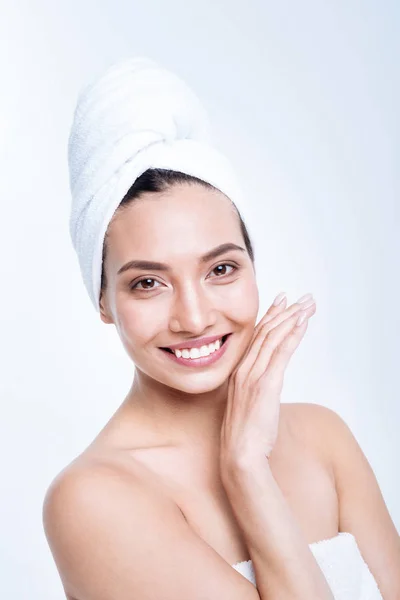 Upbeat young woman smiling while posing in towel turban — Stock Photo, Image