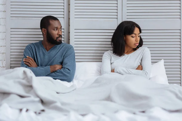 Unhappy young people sitting without talking — Stock Photo, Image