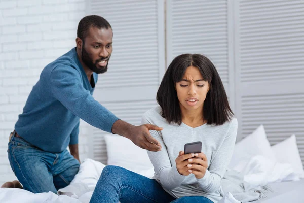 Angry man trying to take his smart phone — Stock Photo, Image