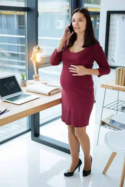 Adorable pregnant woman talking on the telephone — Stock Photo, Image