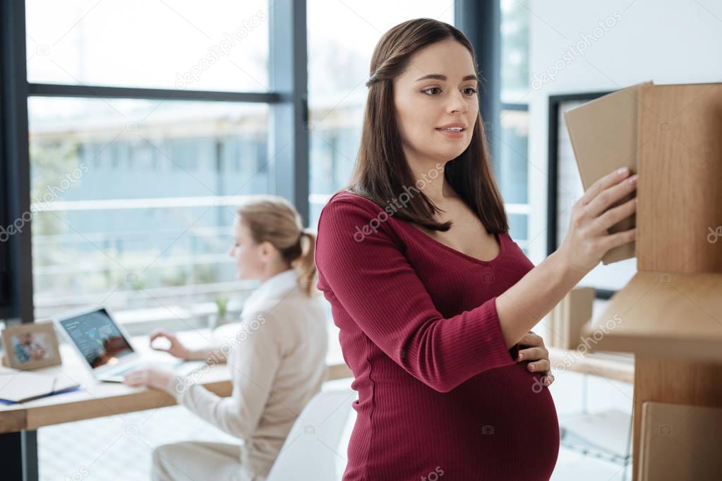 Close up of pregnant woman in the office