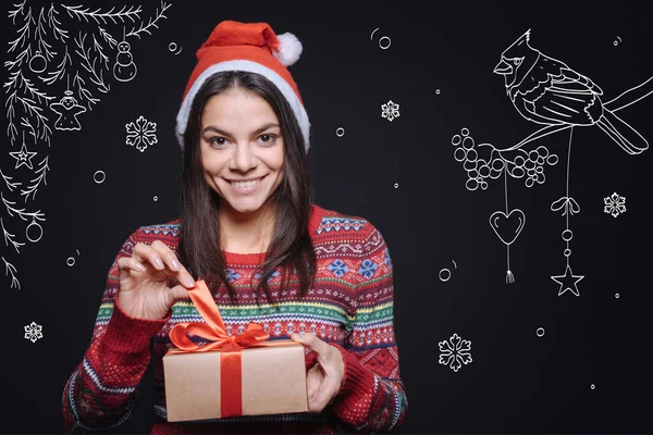 Delighted woman holding the box with a Christmas gift — Stock Photo, Image