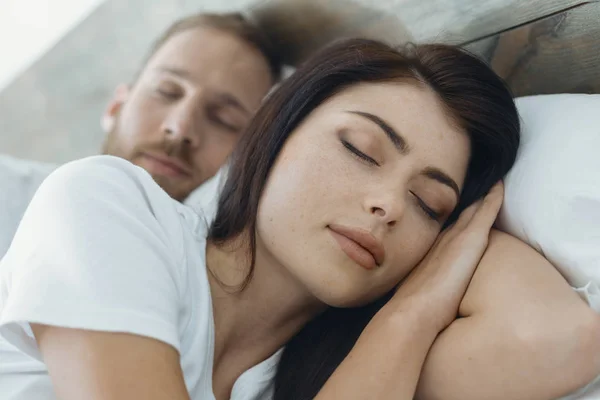 Relaxed woman sleeping near her man — Stock Photo, Image