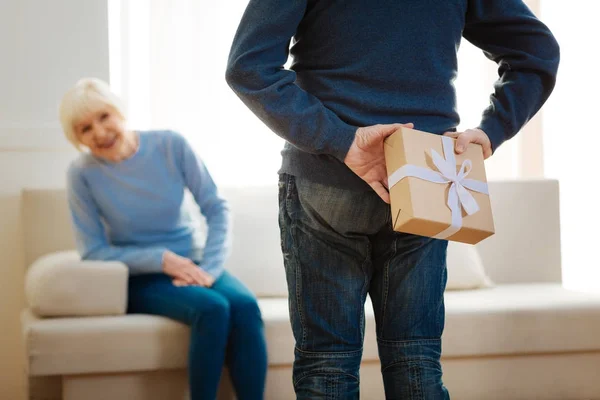 Back view of elderly man that preparing surprise — Stock Photo, Image