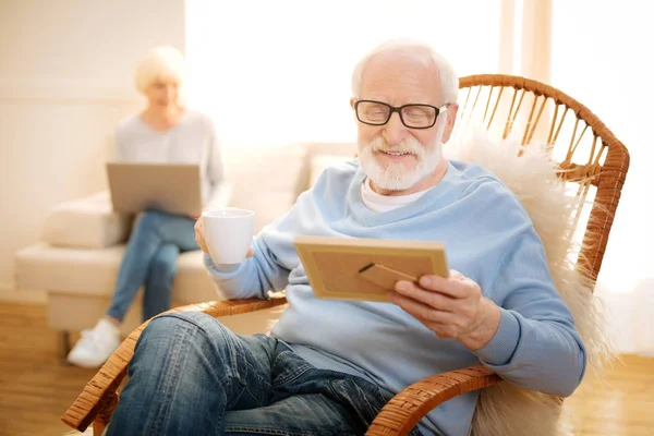 Positief blij mannelijke persoon staren op foto — Stockfoto