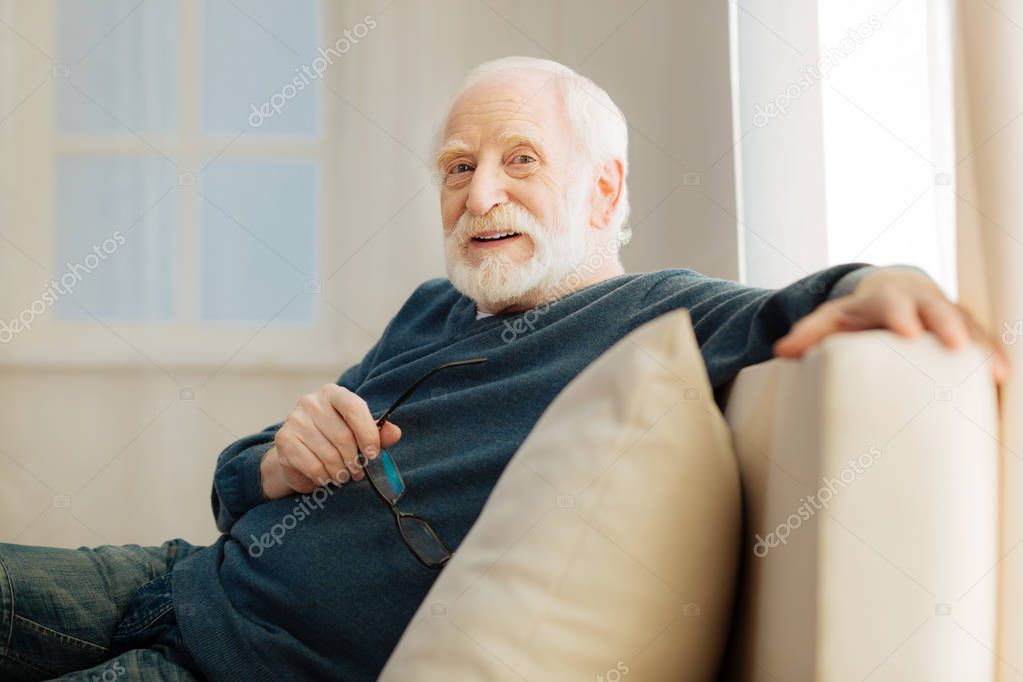 Relaxed old man posing on camera
