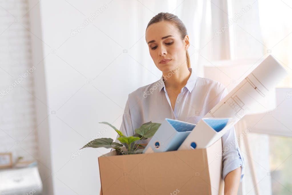 Calm tired woman coming home after being dismissed from work