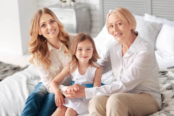 Positive cheerful family sitting together — Stock Photo, Image