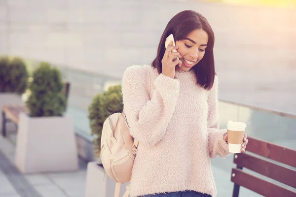 Joyful nice woman talking on the phone