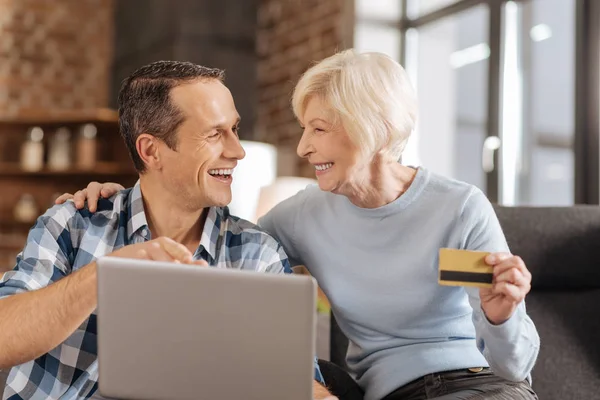 Upbeat elderly mother and son discussing online shopping — Stock Photo, Image