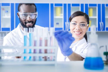 Koruyucu gözlük takan neşeli iyi bilim adamları