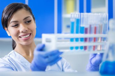 Test tüpü raf tutan mutlu memnun kadın