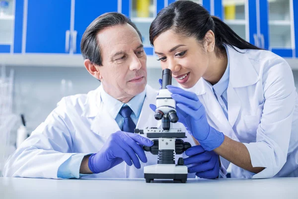 Joyful smart woman standing together with her colleague — Stock Photo, Image
