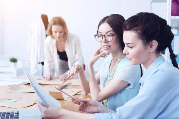 Dos colegas jóvenes que trabajan en el diseño de una nueva colección de moda — Foto de Stock