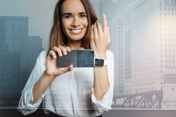 Heureuse belle femme montrant sa smartwatch — Photo