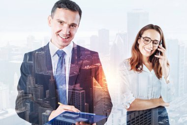 Gülümseyen adam bir klasör meslektaşı telefonda konuşurken süre tutan