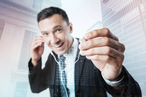 Positive nice man holding headphones — Stock Photo, Image