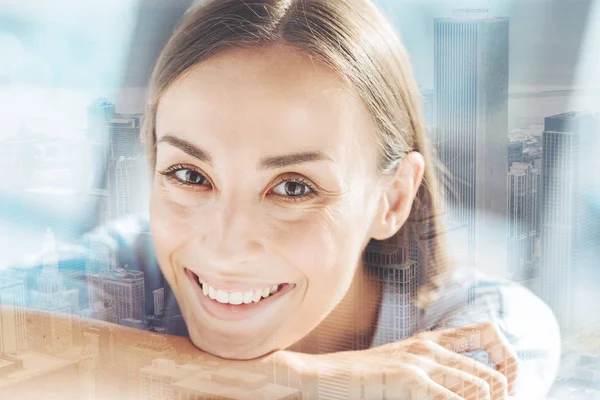 Smiling woman resting her head on arms — Stock Photo, Image