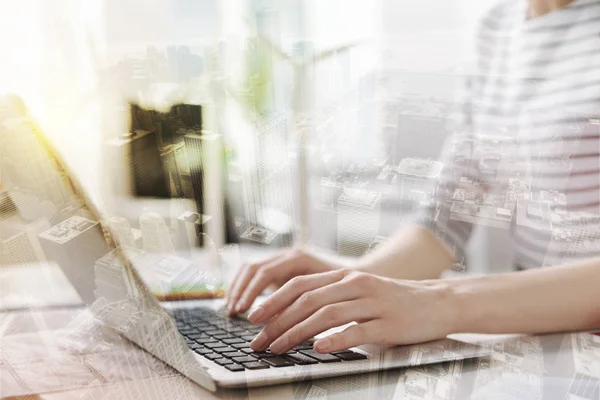 Pleasant female office worker typing on the laptop — Stock Photo, Image