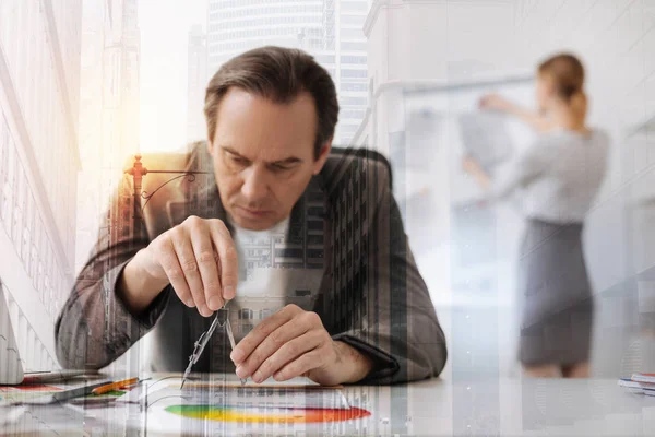 Professional concentrated male engineer using compasses — Stock Photo, Image