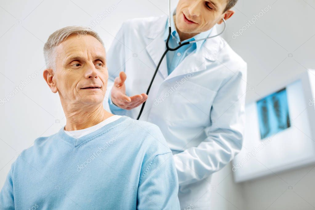 Positive elderly man having a medical checkup