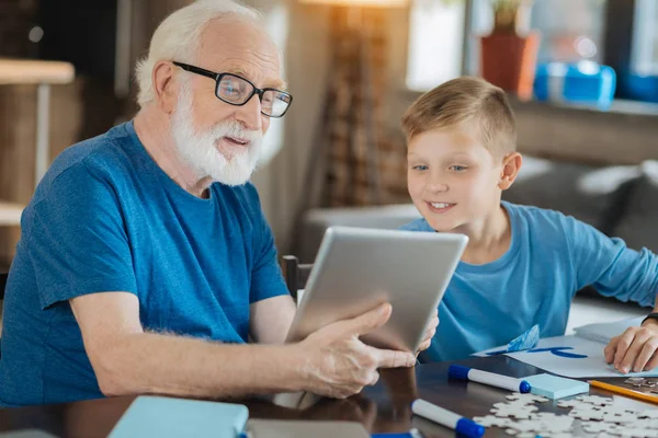 Cheerful elderly man using electronic device — Stock Photo, Image