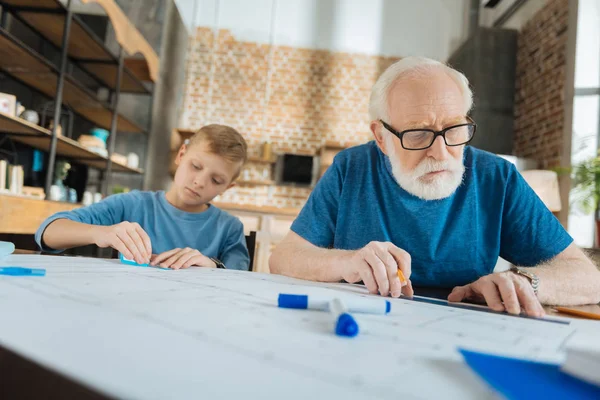 Serious elderly man being involved in work — Stock Photo, Image