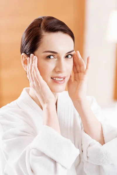 Gay good looking woman touching her temples — Stock Photo, Image