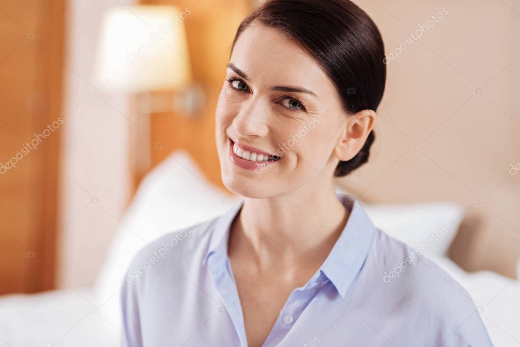 Brunette attractive woman  posing on the blurred background