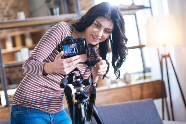 Positive nice woman setting up the camera