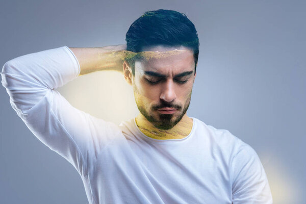 Nice handsome man holding his hand behind the head