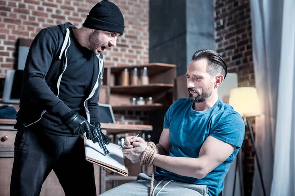 Violent criminal making a man sign a contract — Stock Photo, Image