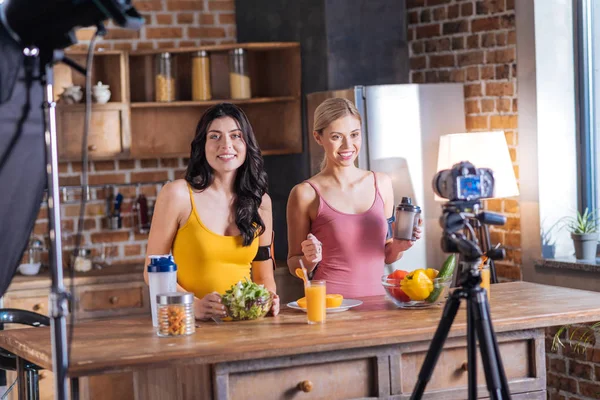 Cheerful female bloggers recording a video