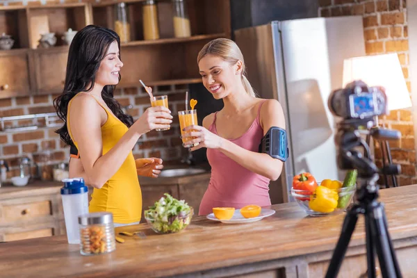 Positive happy women drinking fresh juice — Stock Photo, Image