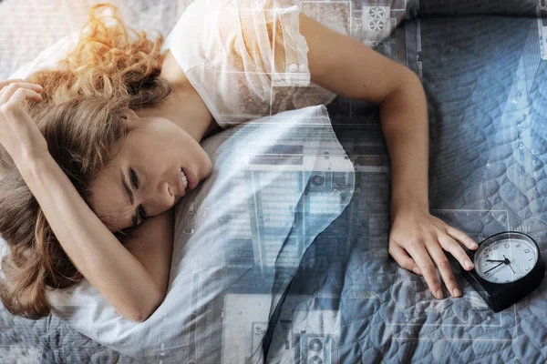 Worried woman lying in her bed — Stock Photo, Image