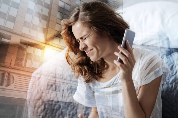 Woman keeping eyes closed and holding phone — Stock Photo, Image