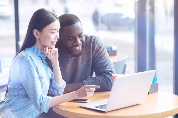 Vriendelijke internationale collega's, kijken naar grappige video — Stockfoto