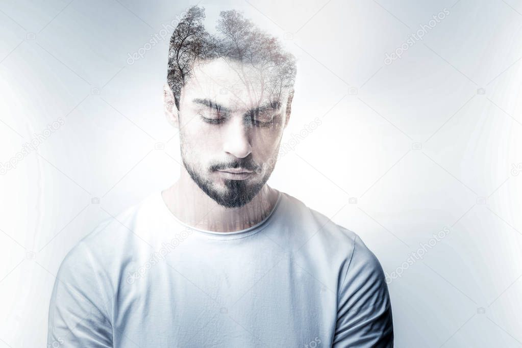 Thoughtful young man bowing his head